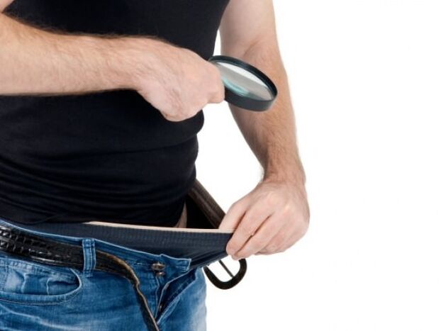 a man takes down his pants and wants to enlarge his penis